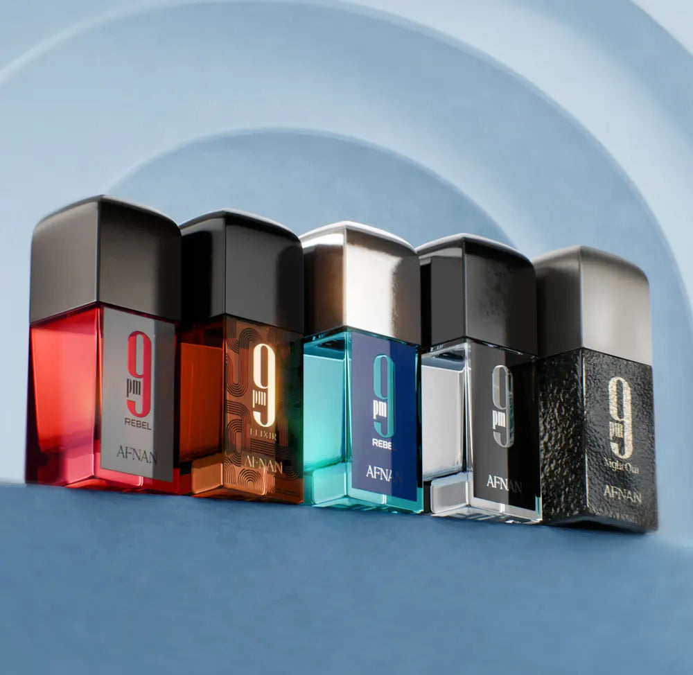 Five bottles lined up against a curved blue wall
